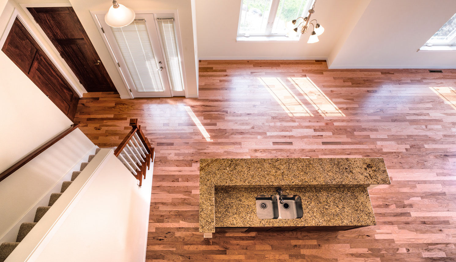 Open kitchen with granite island and hardwood floors